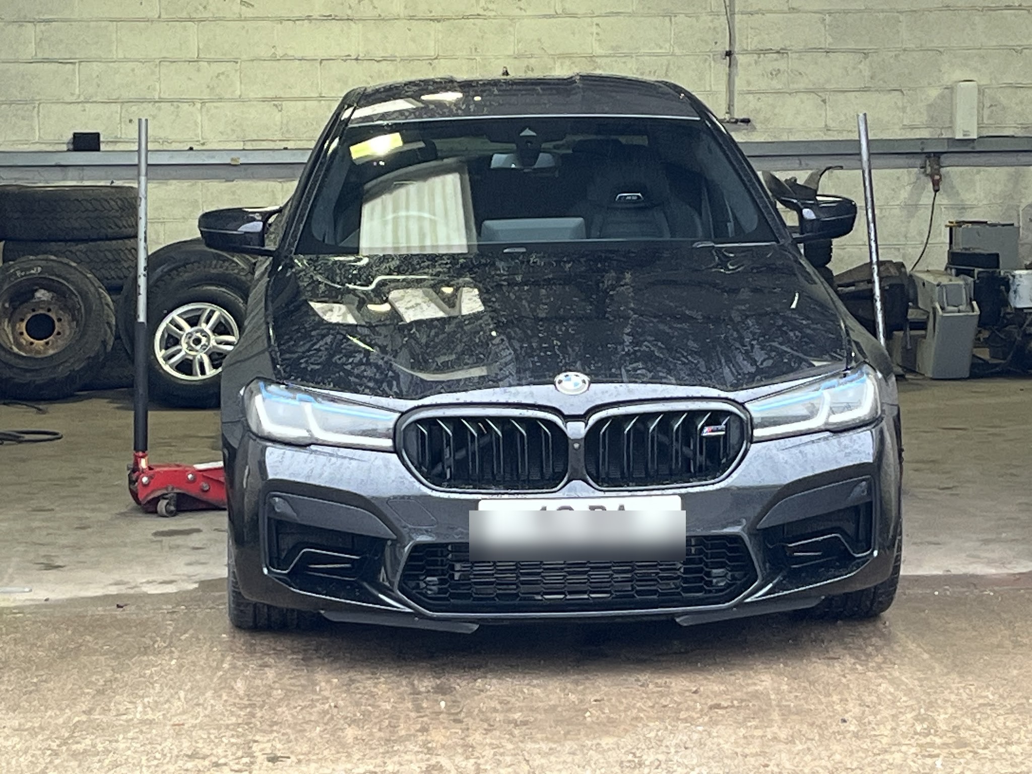 A customer's car in the workshop bay
