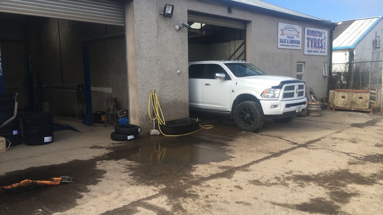 A white pickup in the workshop bay on Cross Lane