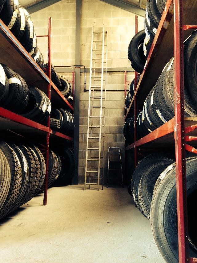 Racks of tyres stacked to the ceiling in the Ulverston Tyres store