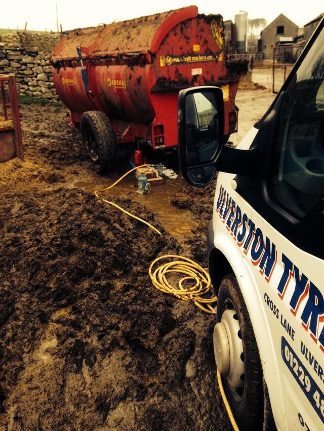 The Ulverston Tyres van pulled up beside a muck spreader in a farmyard